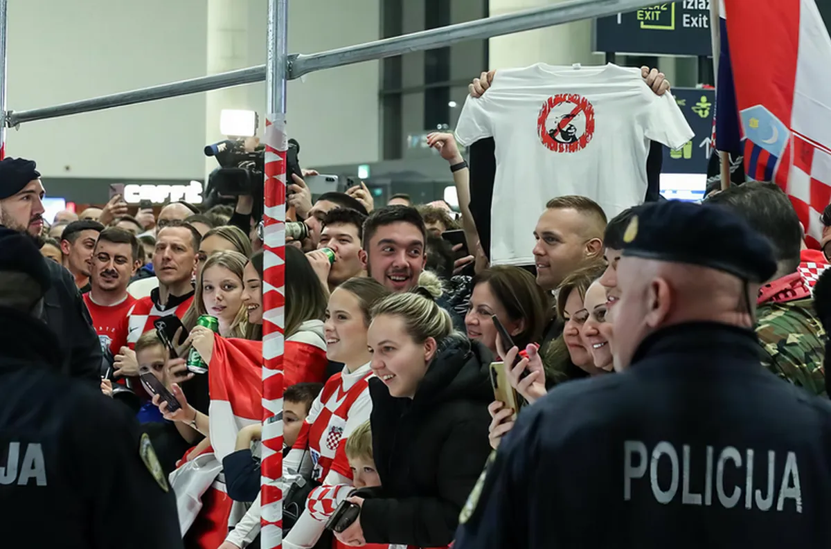 Kis ország, nagy cirkusz: a horvát kézilabdázók ünneplése 2.0 5 A kézilabdázók fogadása a zágrábi Franjo Tuđman repülőtéren, ebből az alkalomból Ivan Martinović, csapatkapitány kijelentette, hogy „nem akarnak a politikába keveredni, de megérdemelnek egy kedves fogadtatást Thompsonnal". A háttérben látható pólón áthúzott arcképe, ebből biztos sok fogy majd a napokban